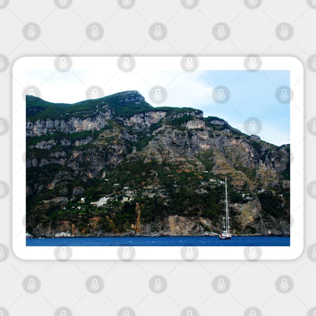 View in Amalfi coast at a huge mountain with rocky parts, greenery and buildings with a white boat underneath Sticker by KristinaDrozd